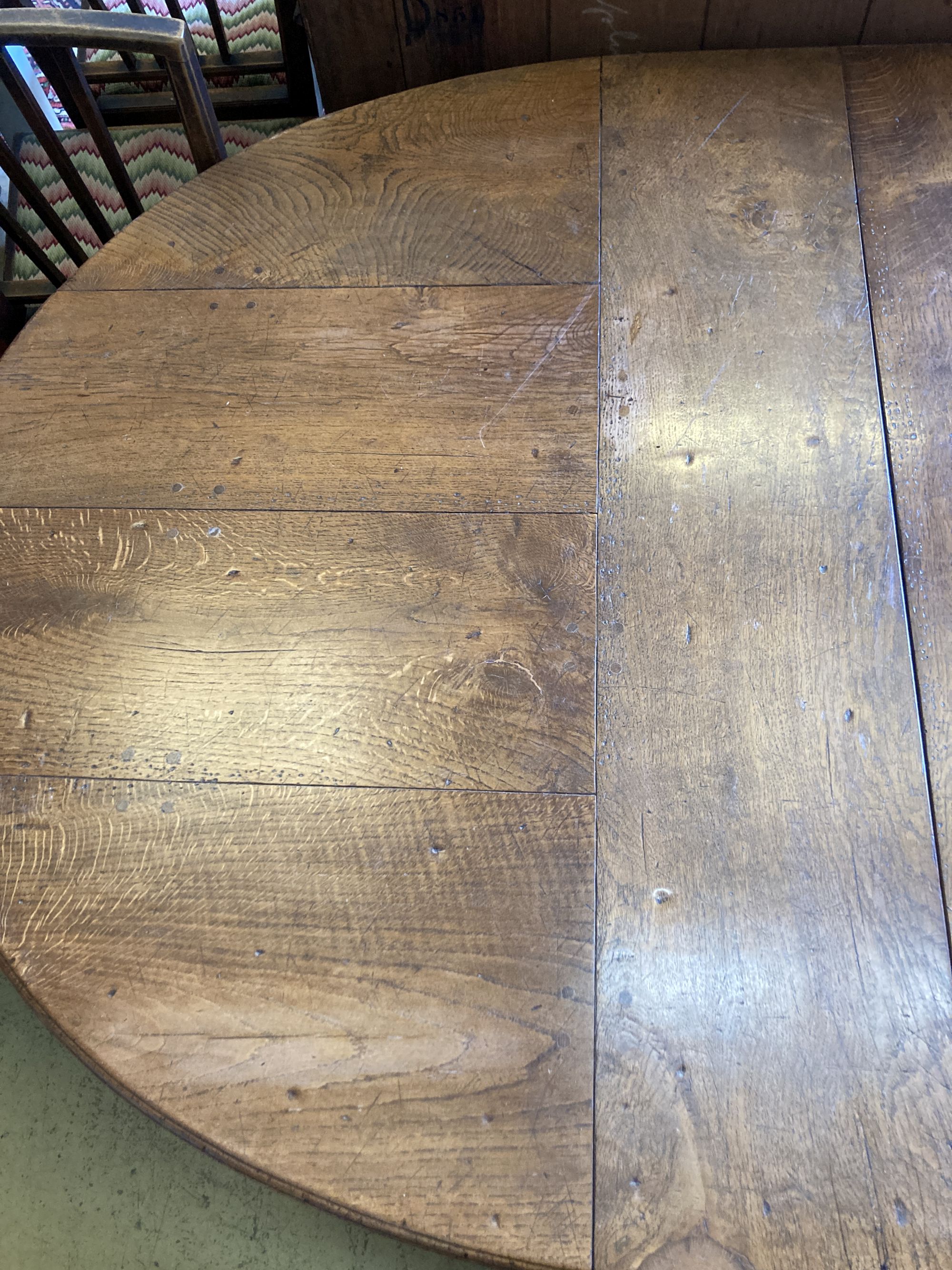 A 17th century style oak dining table, length 268cm extended (two spare leaves), width 122cm, height 74cm